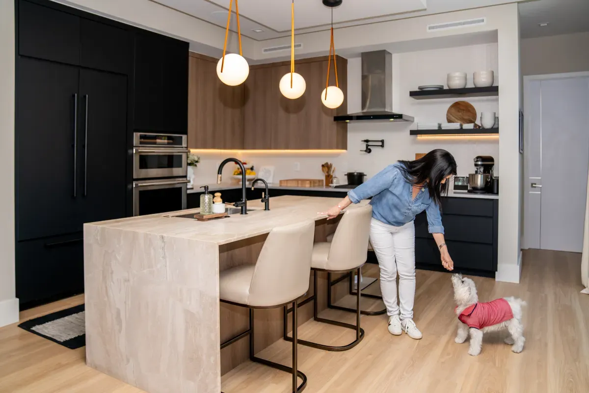 woman in kitchen with dog