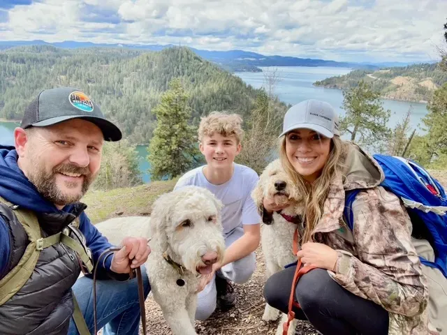 A group hiking with their dogs